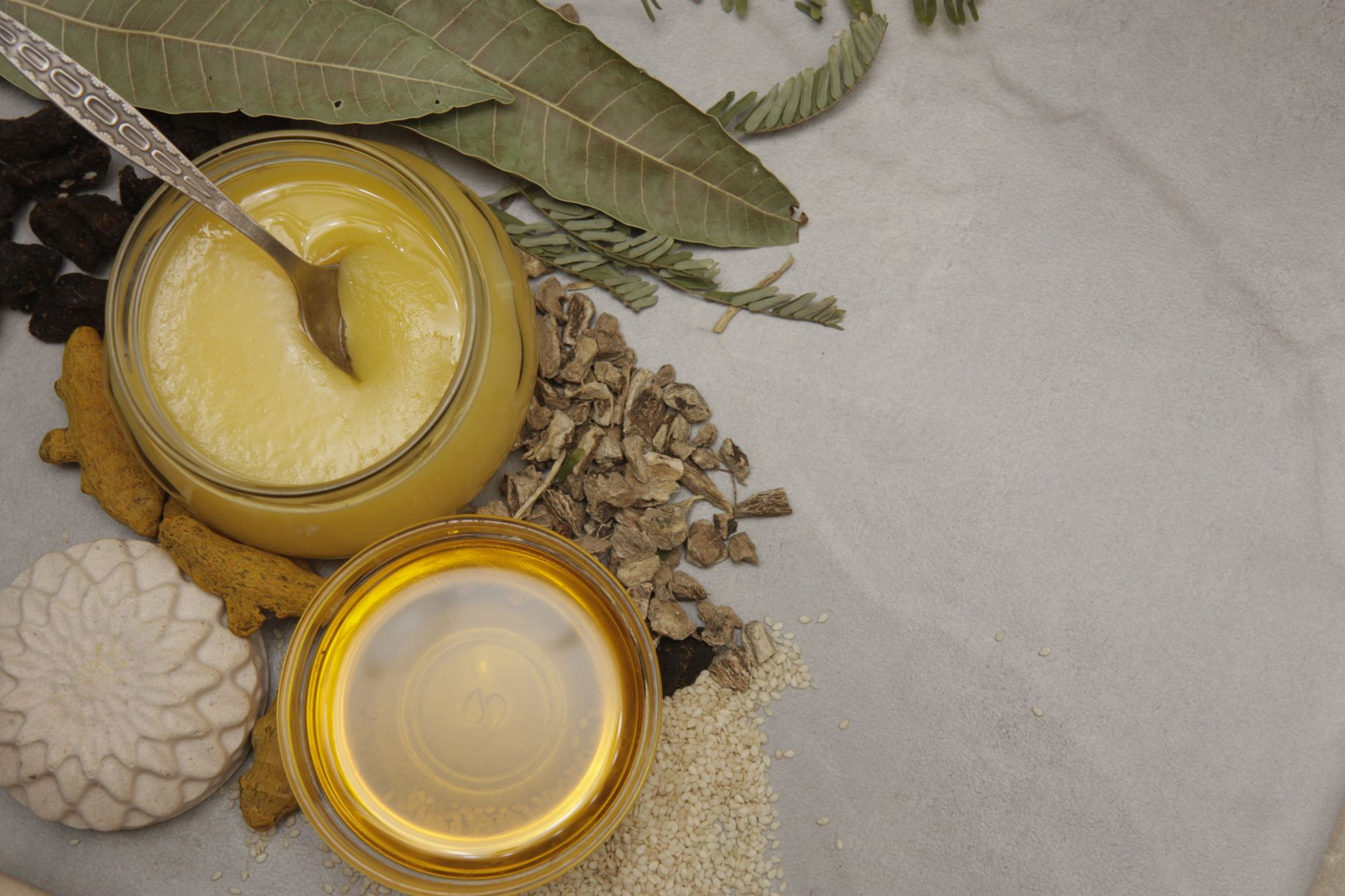 a jar of honey with a spoon
